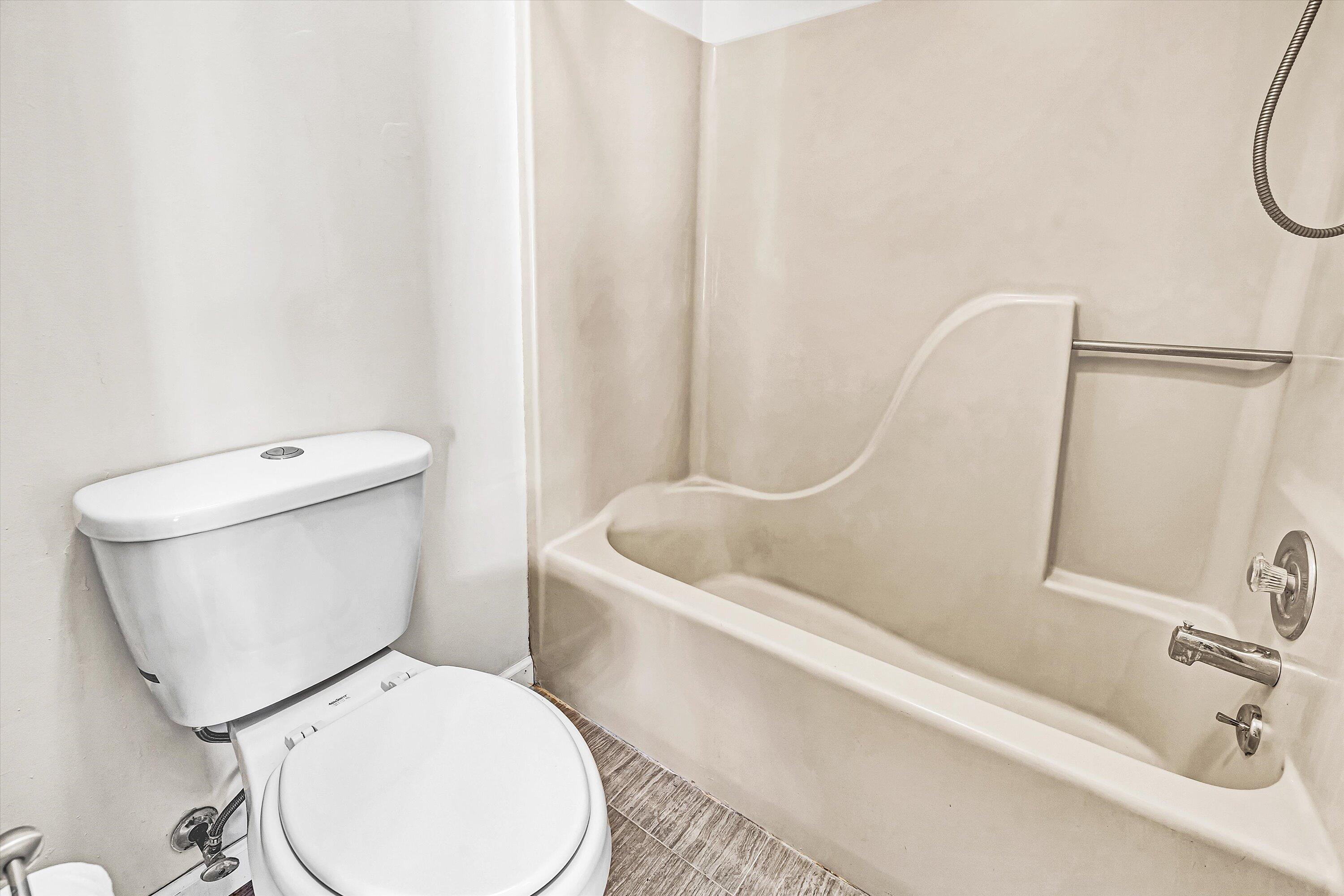 3347 Forest Ridge Road Roanoke, VA 24018 - Photo 14 of 22 a white toilet sitting next to a bath tub