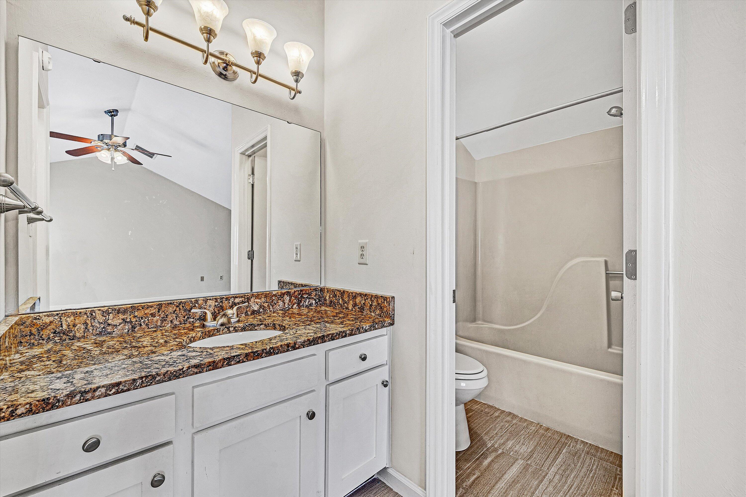 3347 Forest Ridge Road Roanoke, VA 24018 - Photo 17 of 22 a bathroom with a granite countertop sink toilet and shower