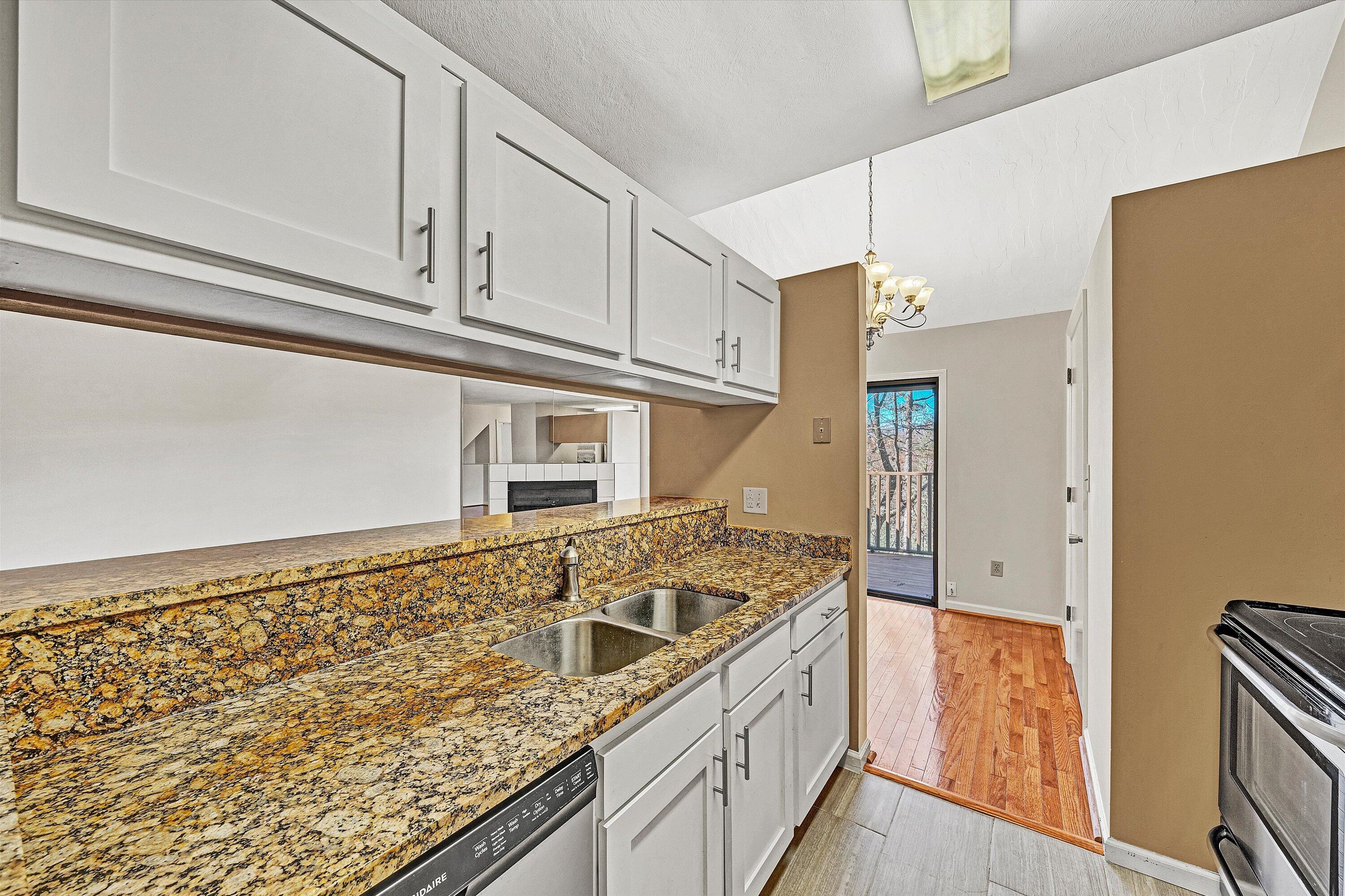 3347 Forest Ridge Road Roanoke, VA 24018 - Photo 6 of 22 a kitchen with granite countertop cabinets a sink and a stove