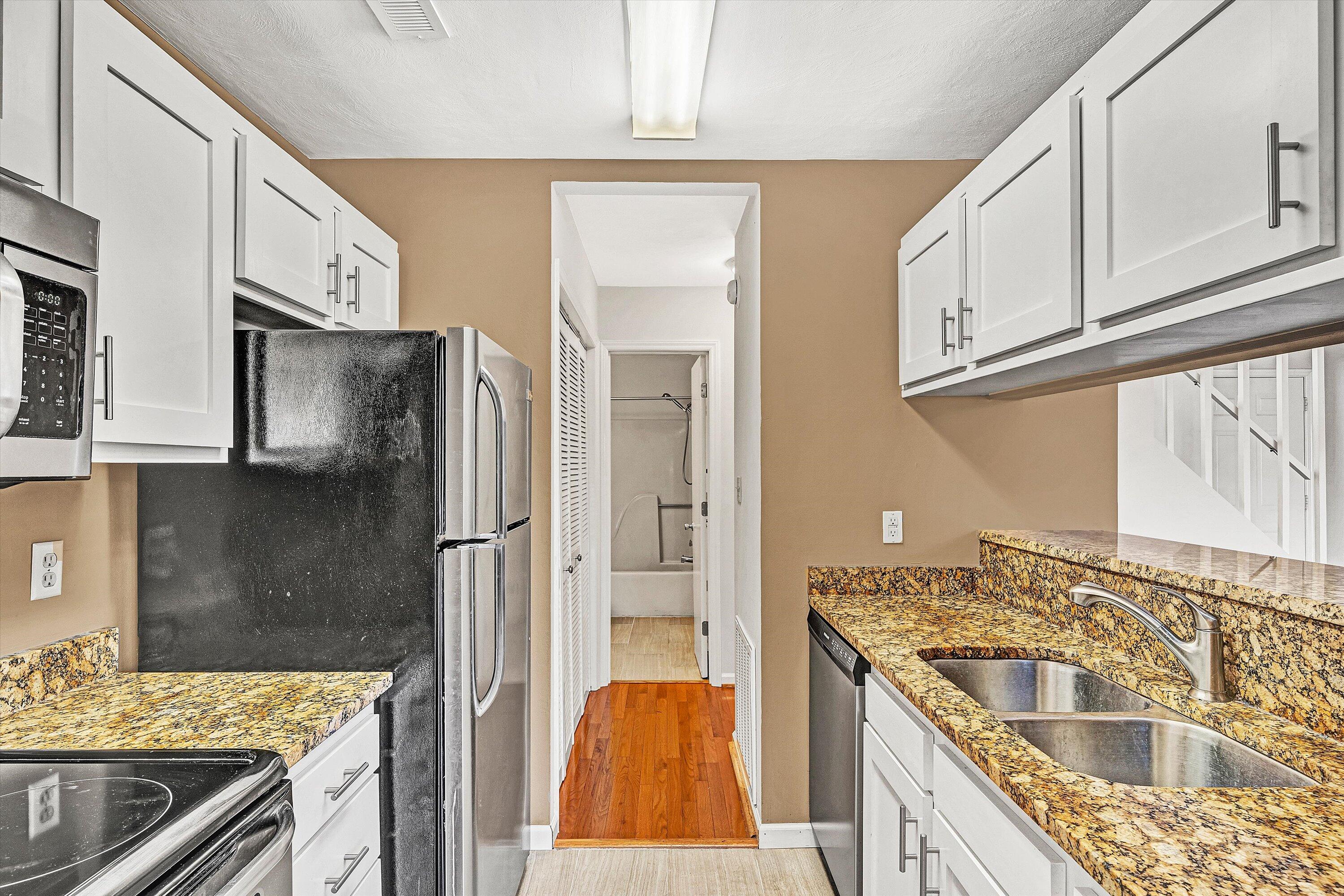 3347 Forest Ridge Road Roanoke, VA 24018 - Photo 7 of 22 a kitchen with stainless steel appliances granite countertop a sink stove and refrigerator