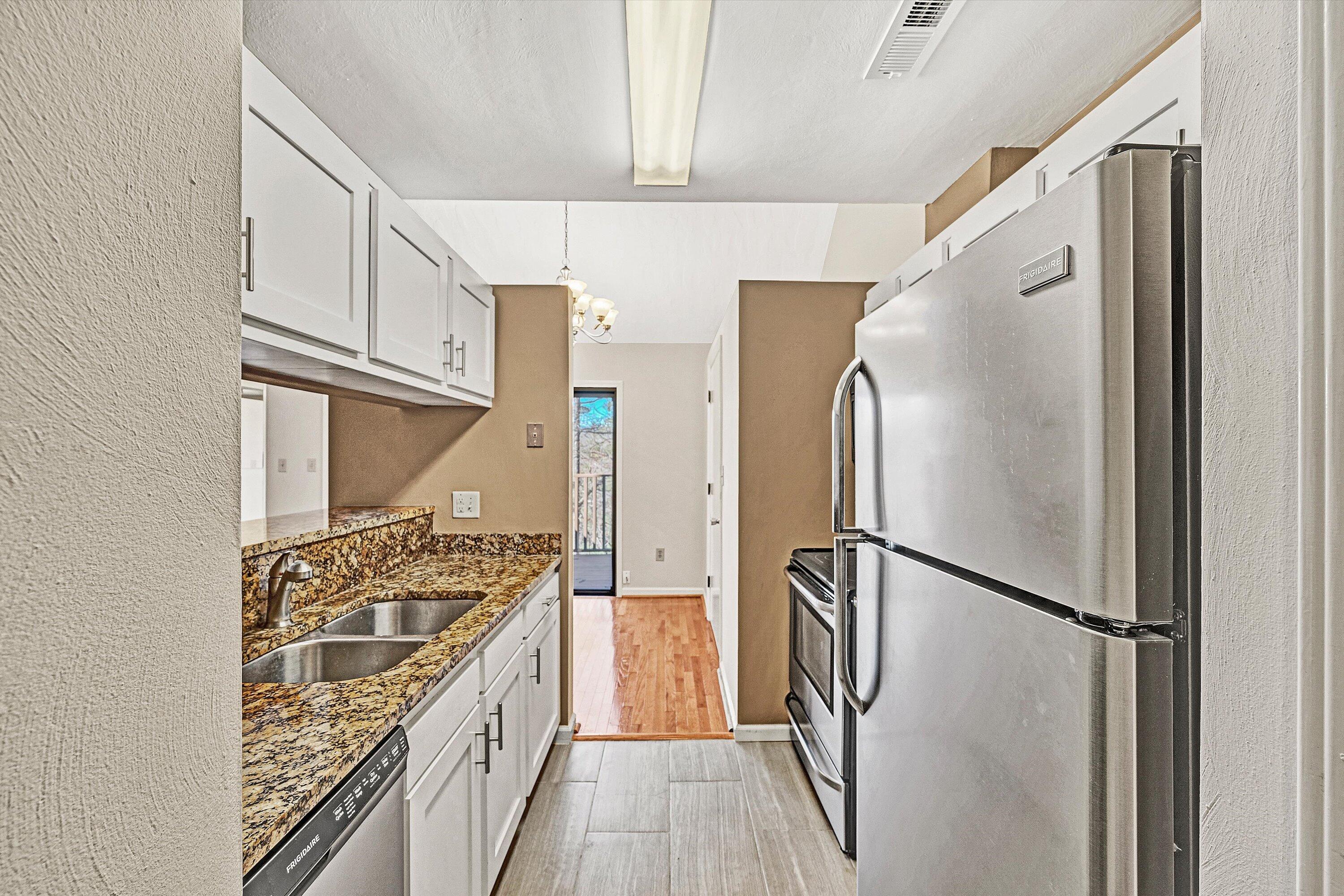 3347 Forest Ridge Road Roanoke, VA 24018 - Photo 8 of 22 a kitchen with granite countertop a refrigerator and a stove top oven
