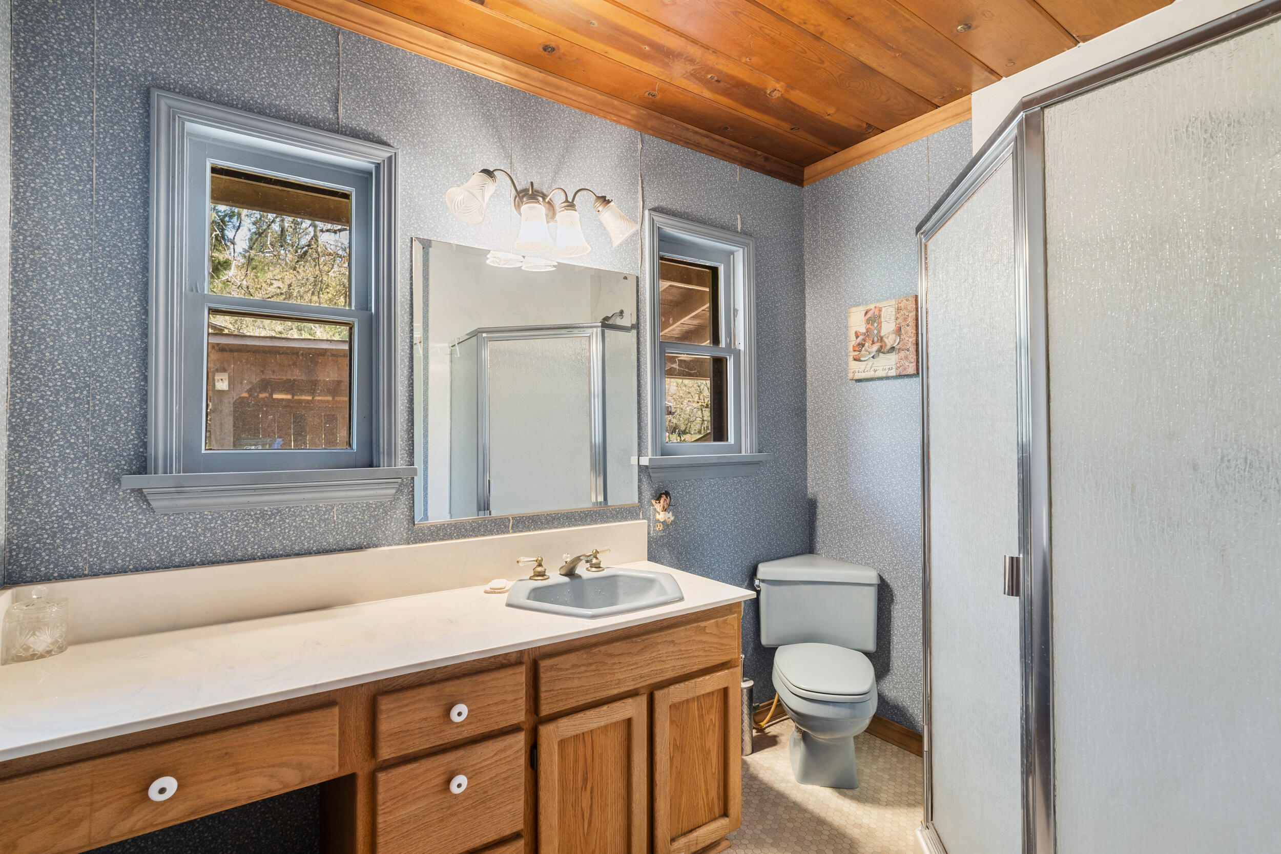 7589 Takilma Road Cave Junction, OR 97523 - Photo 22 of 54 a bathroom with a toilet sink and mirror