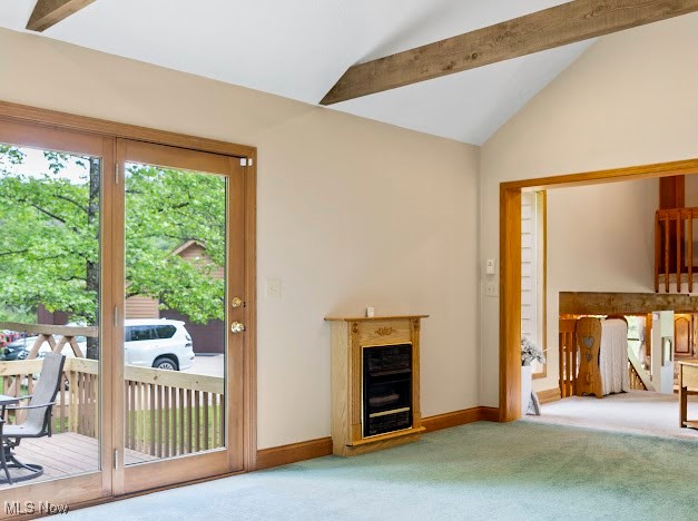 631 Short Brook Road Vincent, OH 45784 - Photo 23 of 31 Unfurnished living room featuring carpet floors, vaulted ceiling, a glass covered fireplace, and baseboards