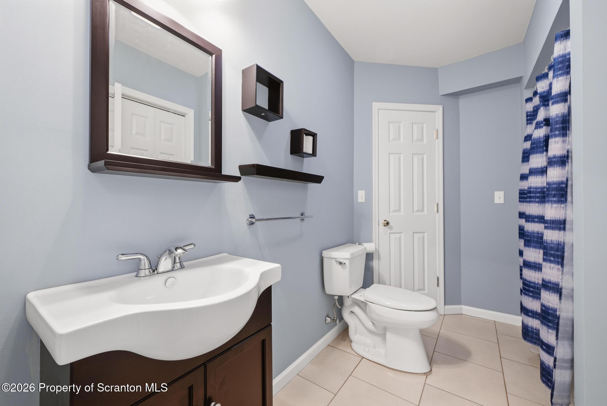 1502 Verne Cl Moosic, PA 18507 - Photo 36 of 46 a bathroom with a toilet sink and mirror