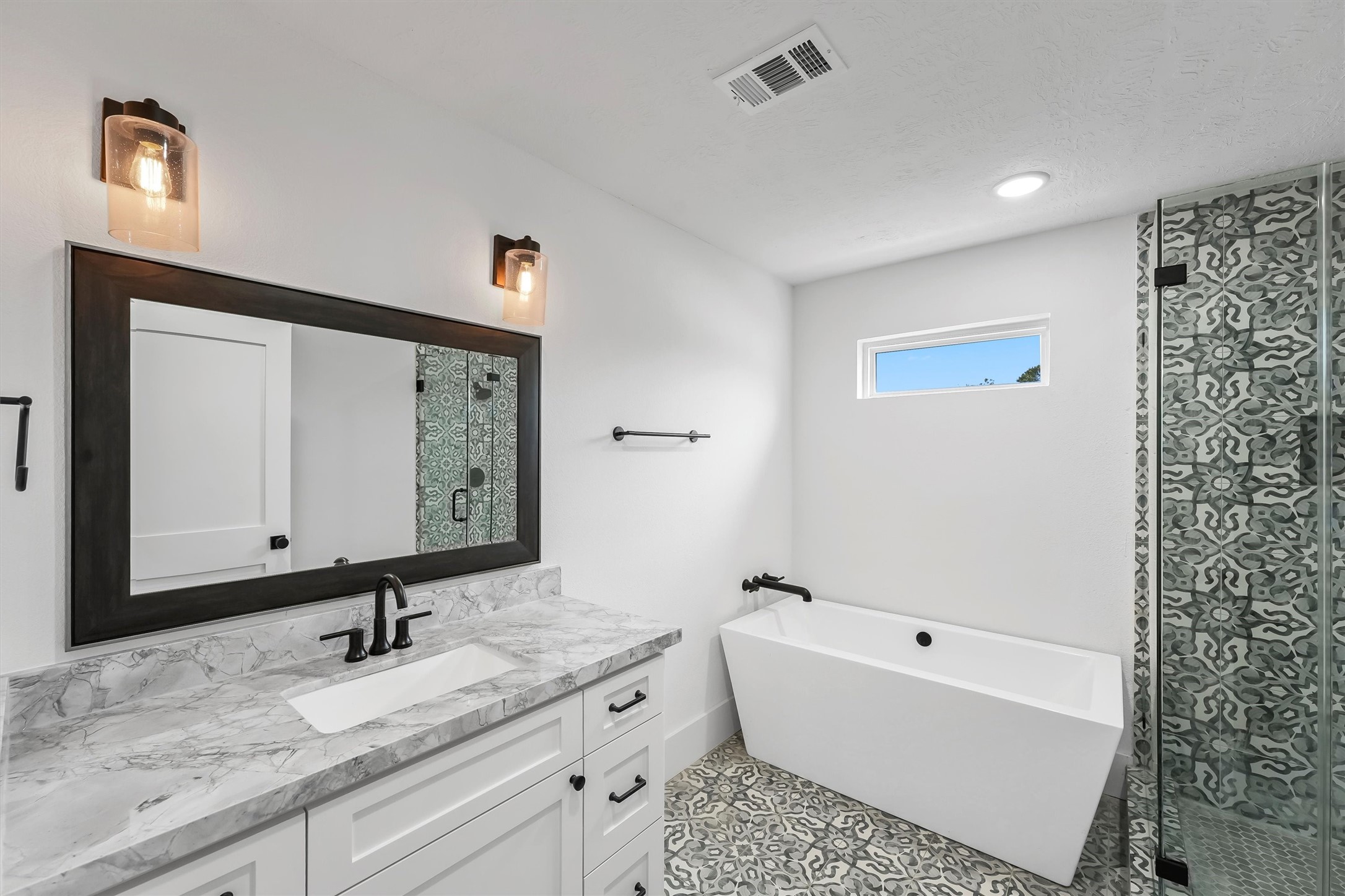 1589 County Road 252 Anderson, TX 77830 - Photo 30 of 50 a bathroom with a granite countertop sink mirror and a bathtub