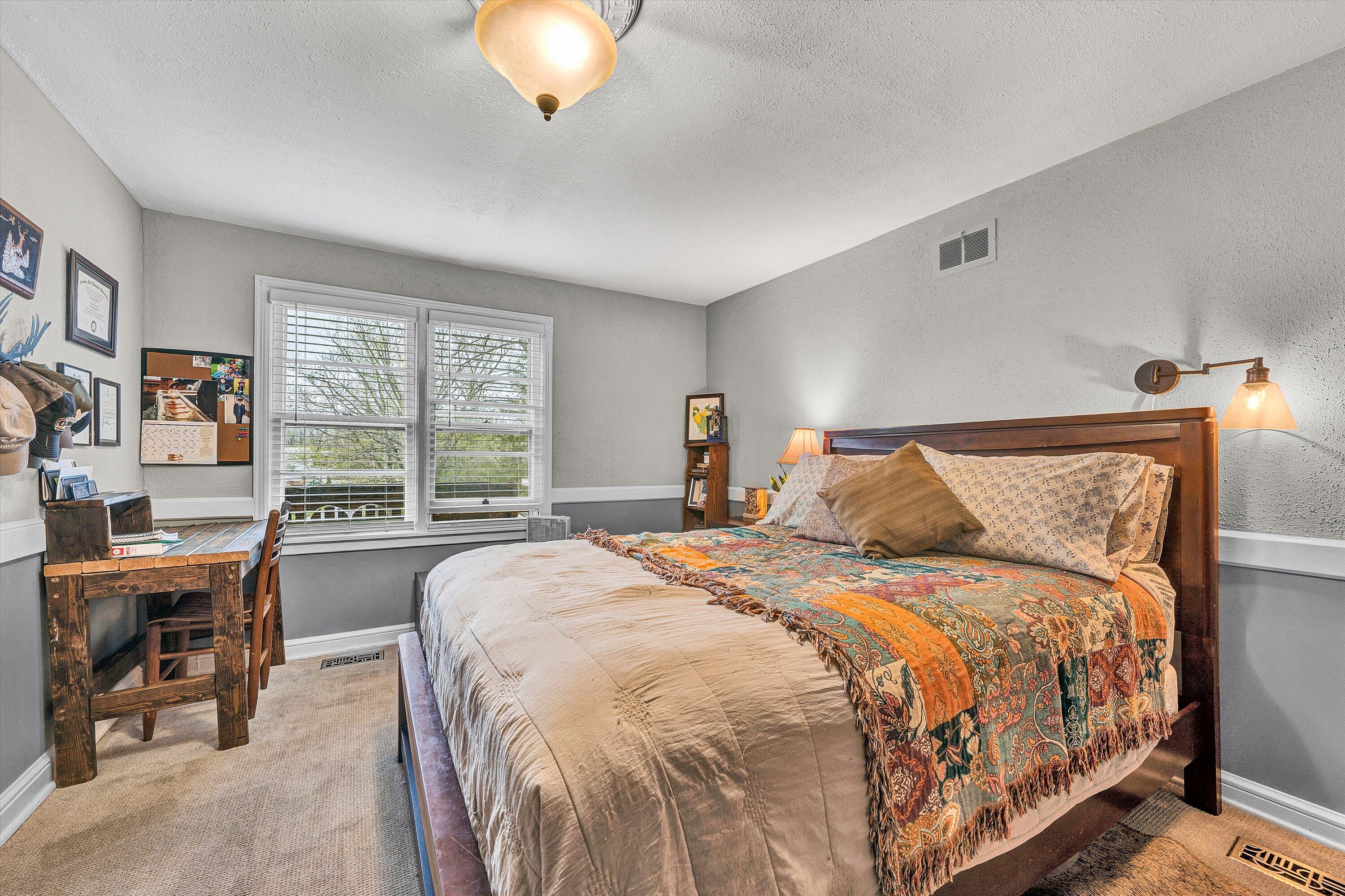 2238 Houston Mines Road Troutville, VA 24175 - Photo 15 of 36 a bed sitting in a bedroom next to a window
