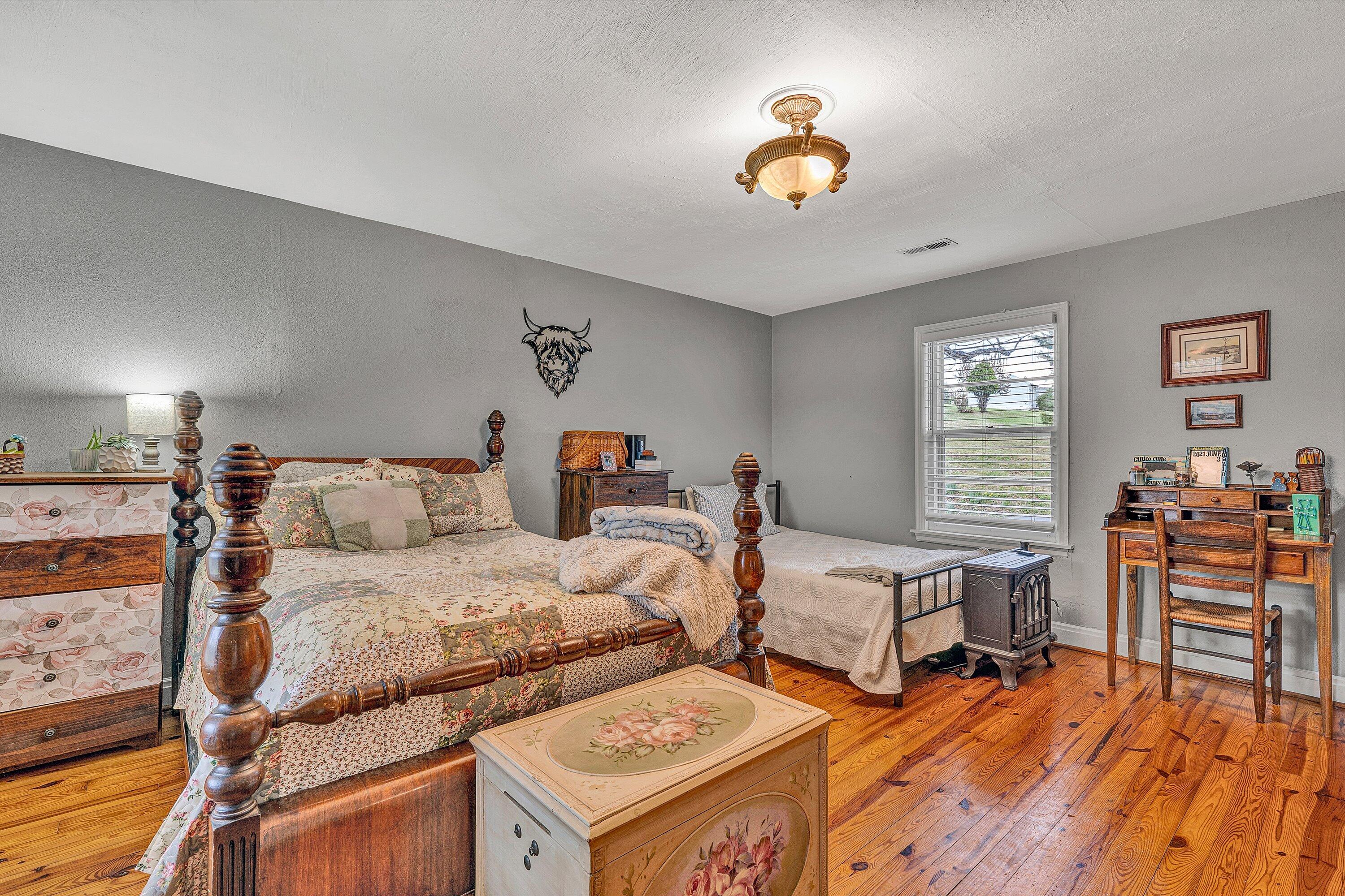 2238 Houston Mines Road Troutville, VA 24175 - Photo 23 of 36 a bedroom with two beds and a chandelier