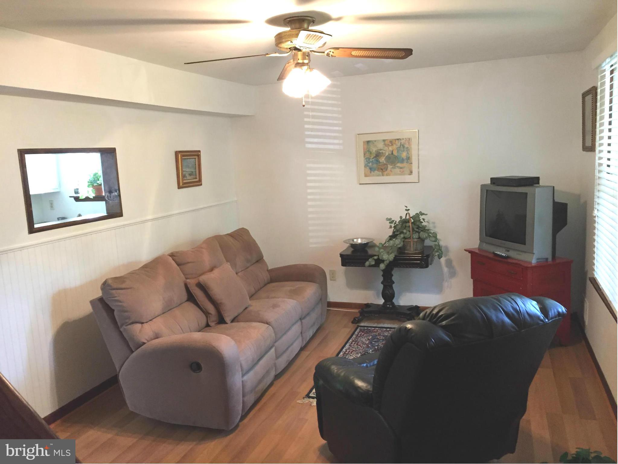 1539 Mayfield Road Edgewater, MD 21037 - Photo 2 of 17 a living room with furniture and a flat screen tv