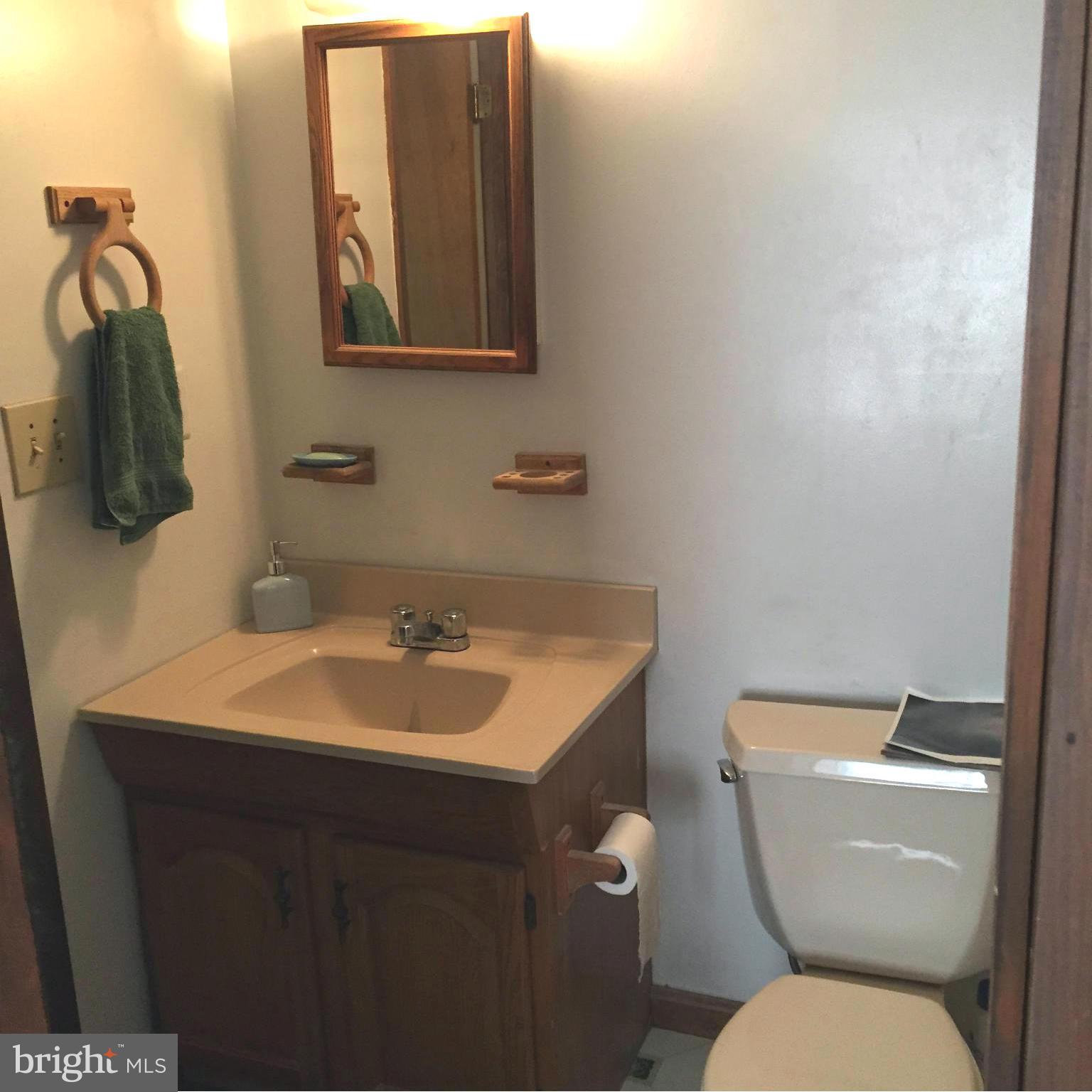 1539 Mayfield Road Edgewater, MD 21037 - Photo 5 of 17 a bathroom with a toilet sink and mirror