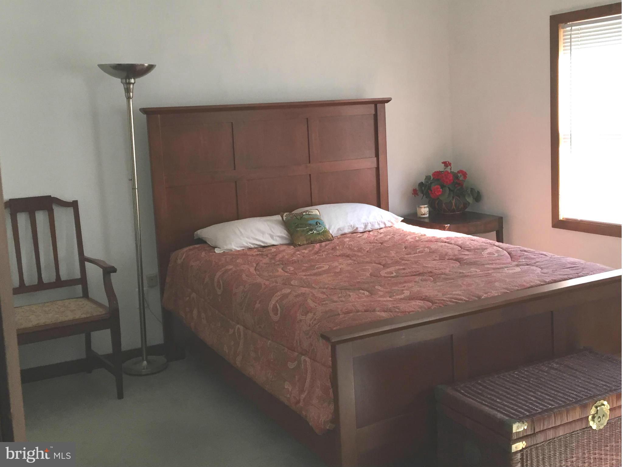 1539 Mayfield Road Edgewater, MD 21037 - Photo 7 of 17 a bedroom with a bed and a potted plant