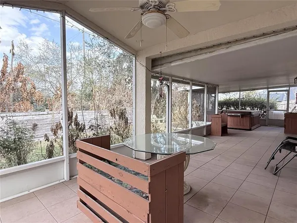 a view of living room with furniture and large windows