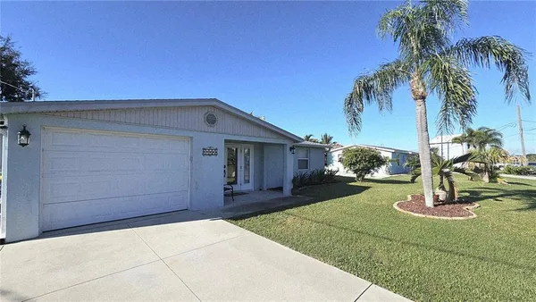 a front view of a house with a garden and yard