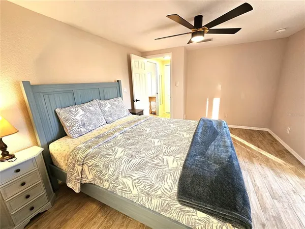 a bed sitting in a bedroom next to a window