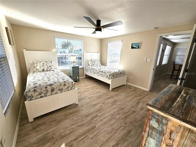 a bedroom with a bed and a large window