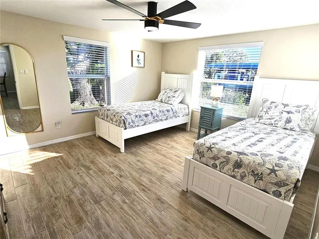a bedroom with two beds and a dresser