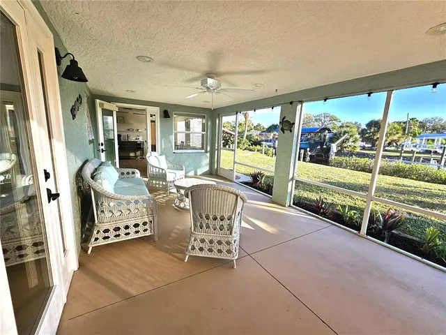 a view of a porch with furniture and a yard