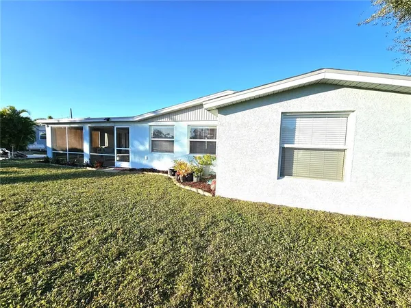 a view of a house with a backyard