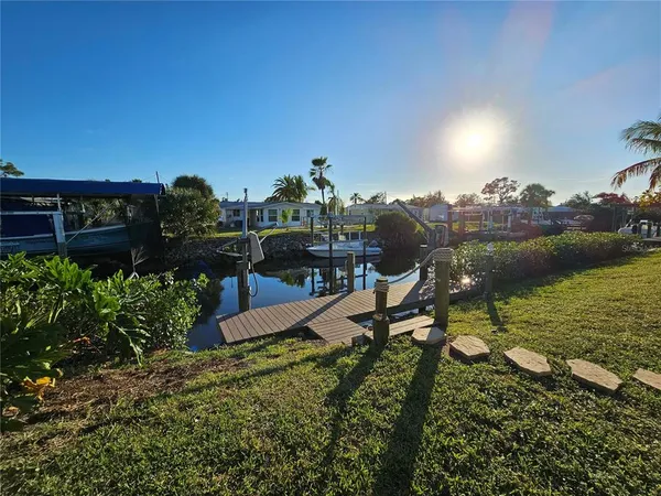 an aerial view of a house with a garden and lake view