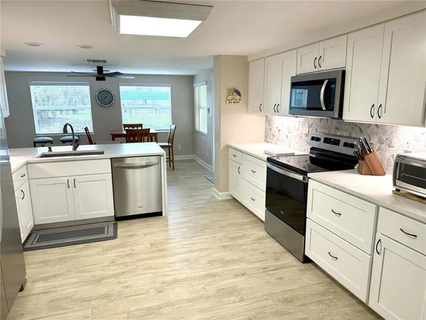 a kitchen with a stove top oven sink and cabinets