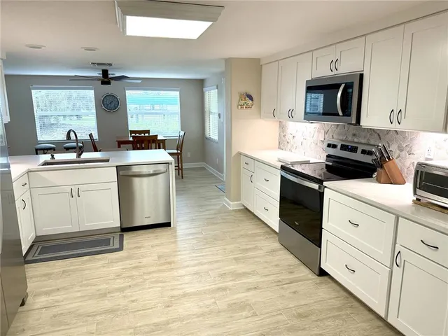 a kitchen with a stove top oven sink and cabinets