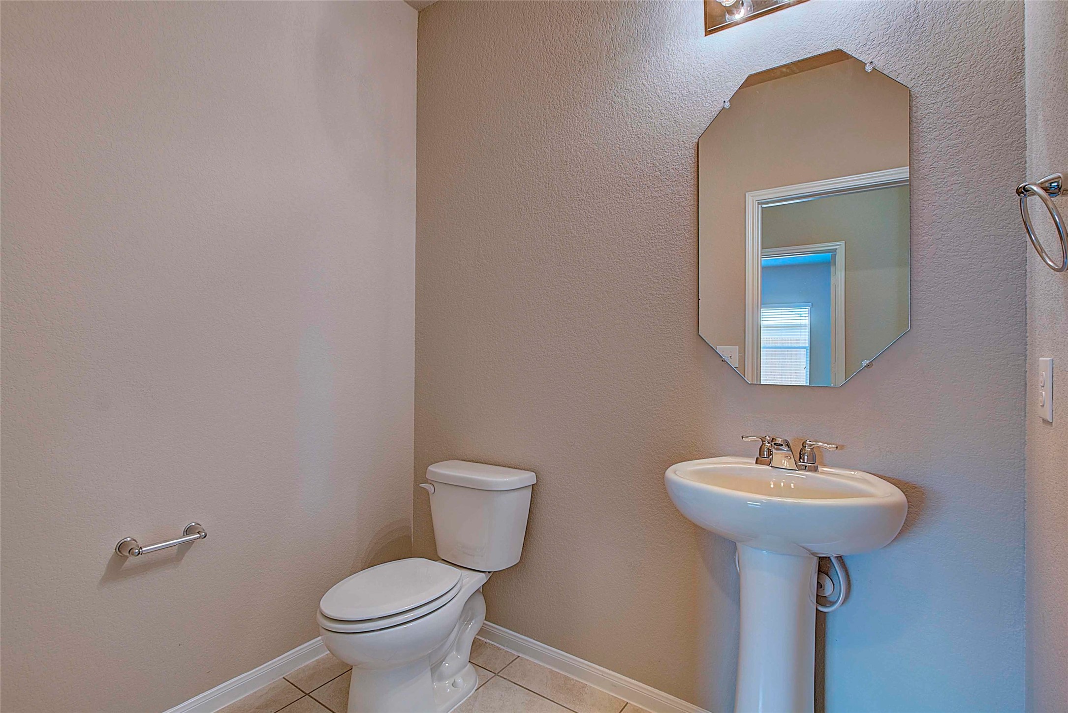 10404 Hatton Lane Austin, TX 78754 - Photo 11 of 27 a bathroom with a toilet sink and mirror