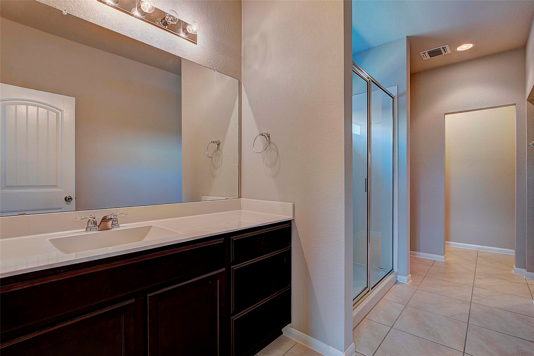 10404 Hatton Lane Austin, TX 78754 - Photo 14 of 27 a bathroom with a double vanity sink and a mirror