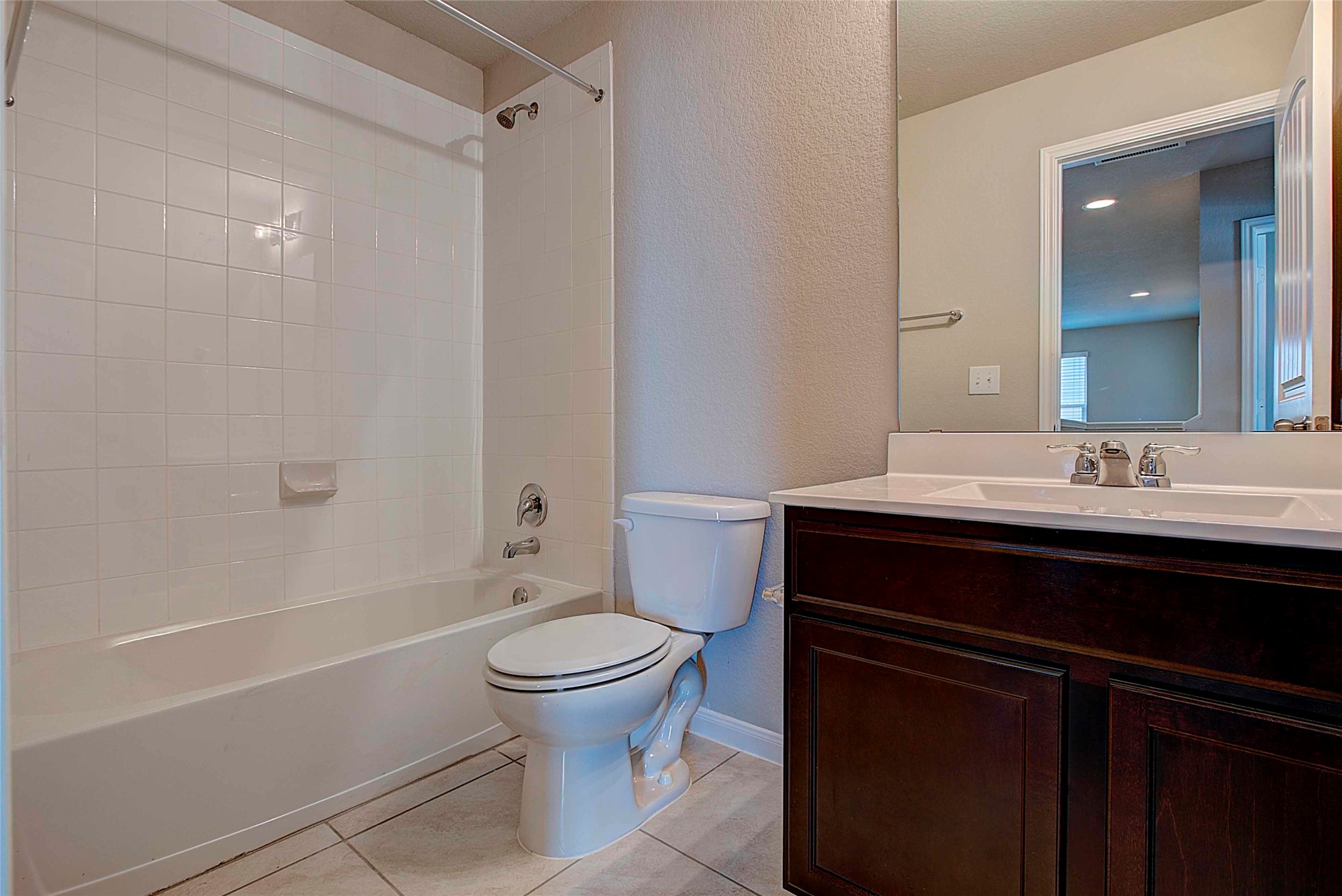 10404 Hatton Lane Austin, TX 78754 - Photo 23 of 27 a bathroom with a sink a toilet a mirror and shower
