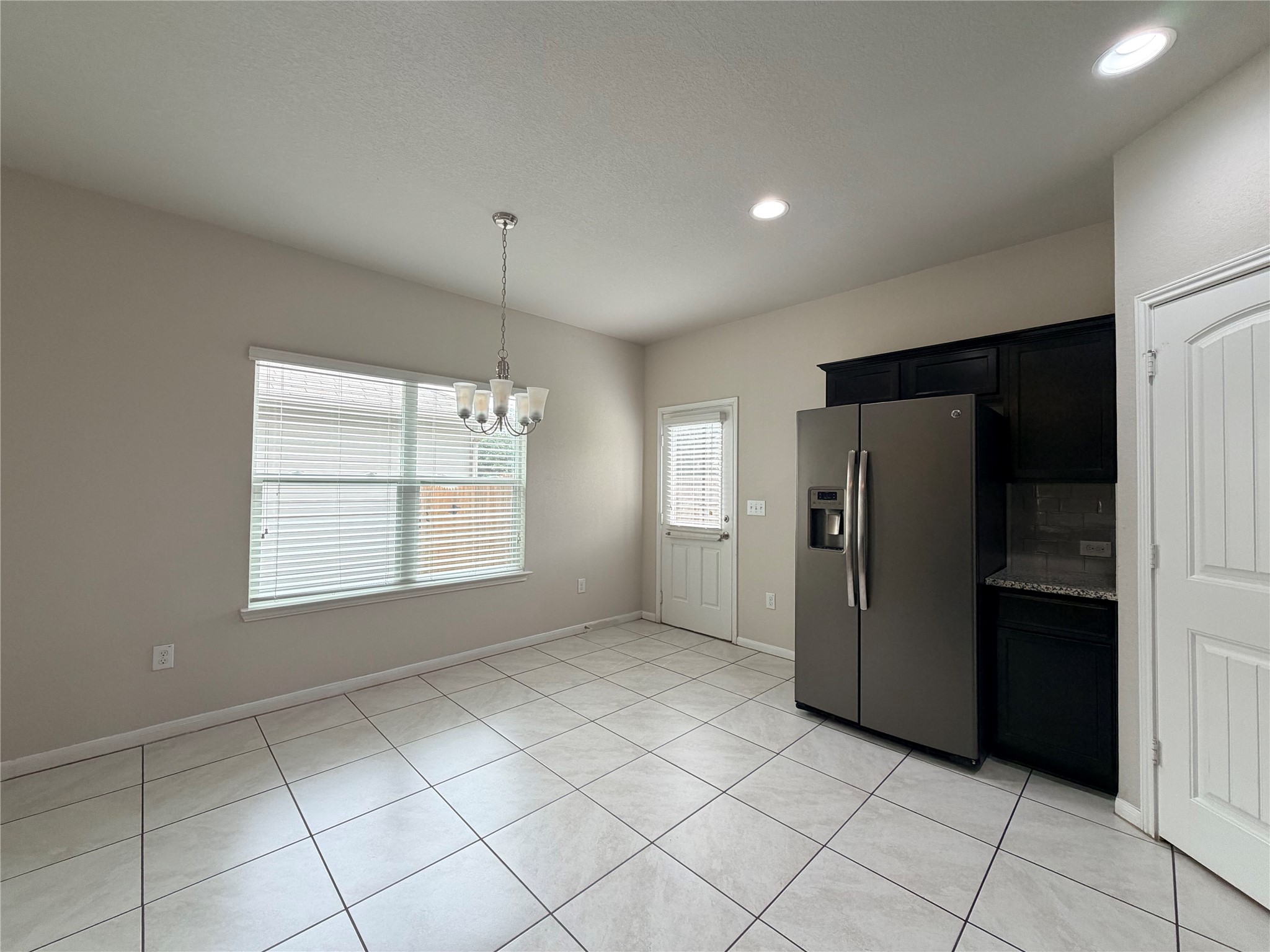 10404 Hatton Lane Austin, TX 78754 - Photo 10 of 27 a view of a kitchen with a refrigerator cabinet and a window