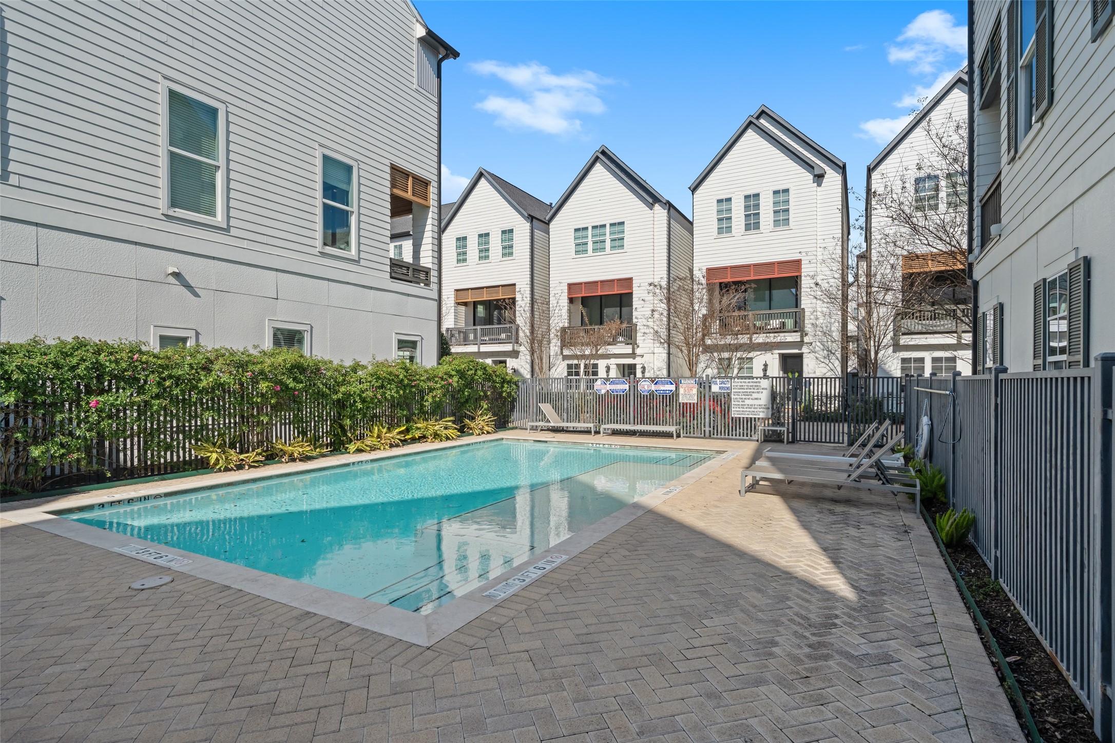 3307 Timbergrove Oaks Street Houston, TX 77008 - Photo 2 of 33 a view of a white house with swimming pool lawn chairs and plants