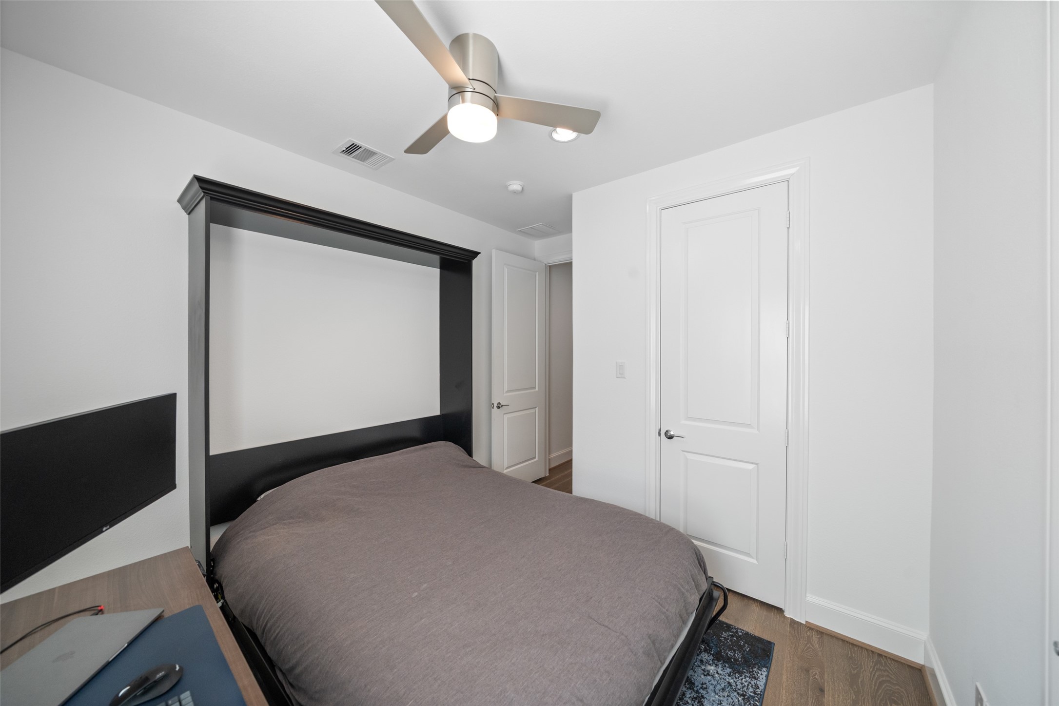 3307 Timbergrove Oaks Street Houston, TX 77008 - Photo 26 of 33 a bedroom with a bed and a chandelier