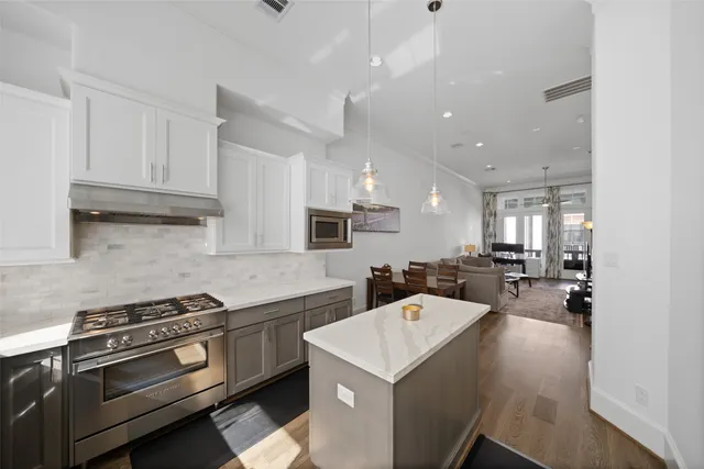 a kitchen with a sink a stove and cabinets