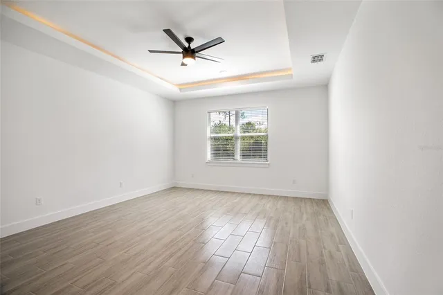 a view of a room with wooden floor and window