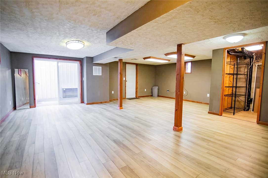 91 Mike Street Washington, WV 26181 - Photo 25 of 42 Basement featuring a textured ceiling and light wood-style flooring