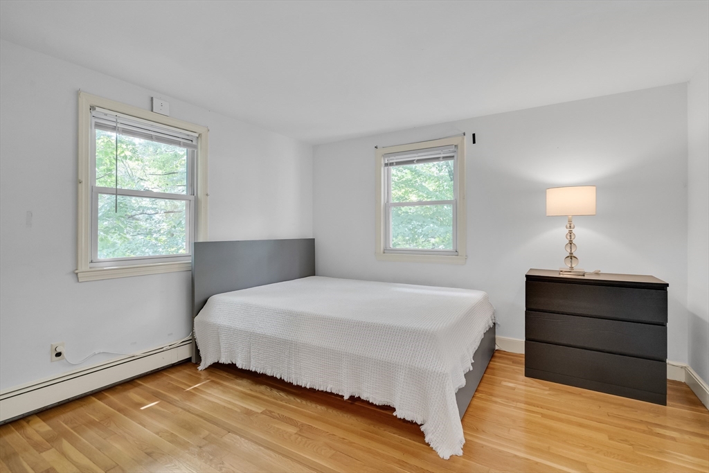 32 Dewey Road Lexington, MA 02420 - Photo 25 of 32 a bedroom with a bed and a lamp on dresser