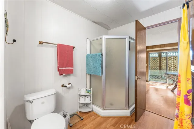 a bathroom with a toilet and a shower