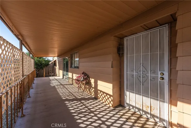 a view of patio with dining table and chairs under an umbrella