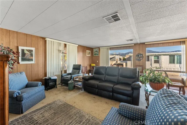 a living room with furniture ceiling fan and a rug