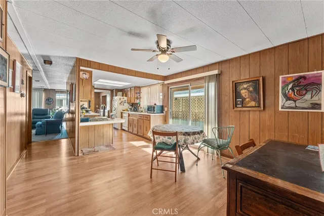 a view of a dining room with furniture a chandelier and wooden floor