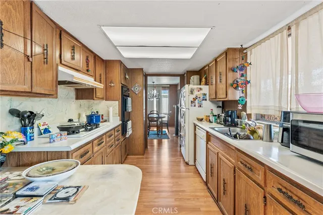 a kitchen with stainless steel appliances kitchen island granite countertop a sink and cabinets