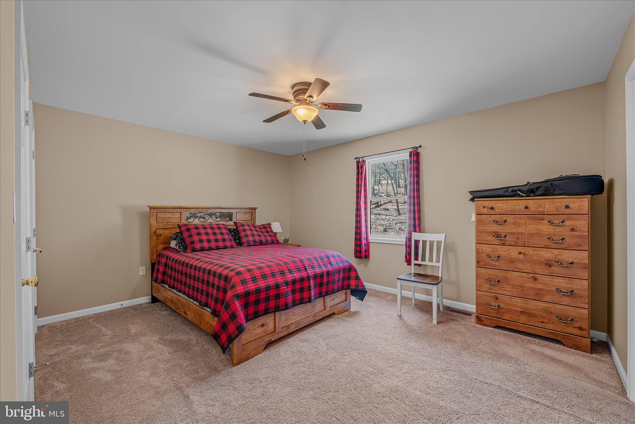 2910 Milo School Road Great Cacapon, WV 25422 - Photo 18 of 55 a room with a bed and a ceiling fan