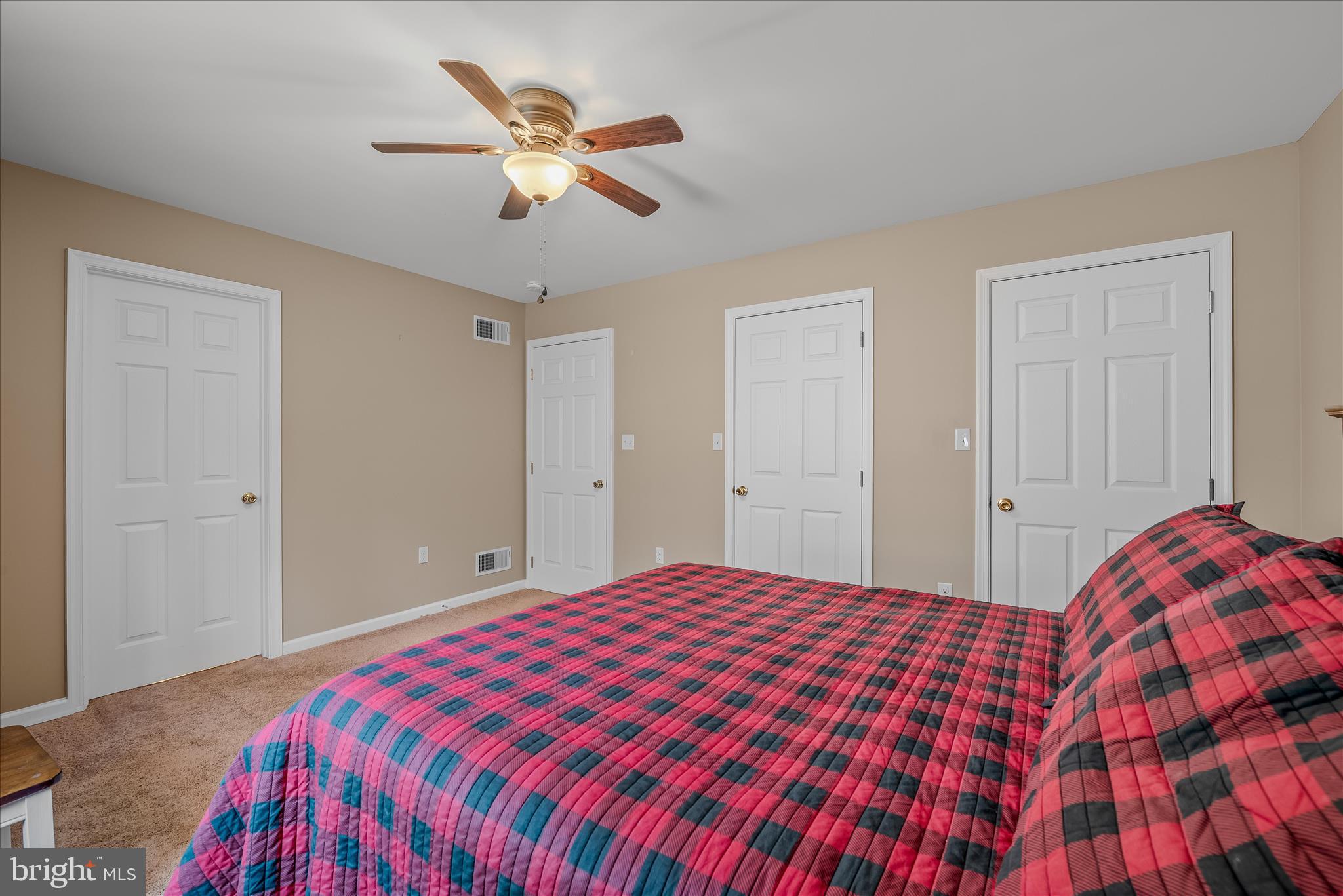 2910 Milo School Road Great Cacapon, WV 25422 - Photo 19 of 55 a bedroom with a large bed and a chandelier