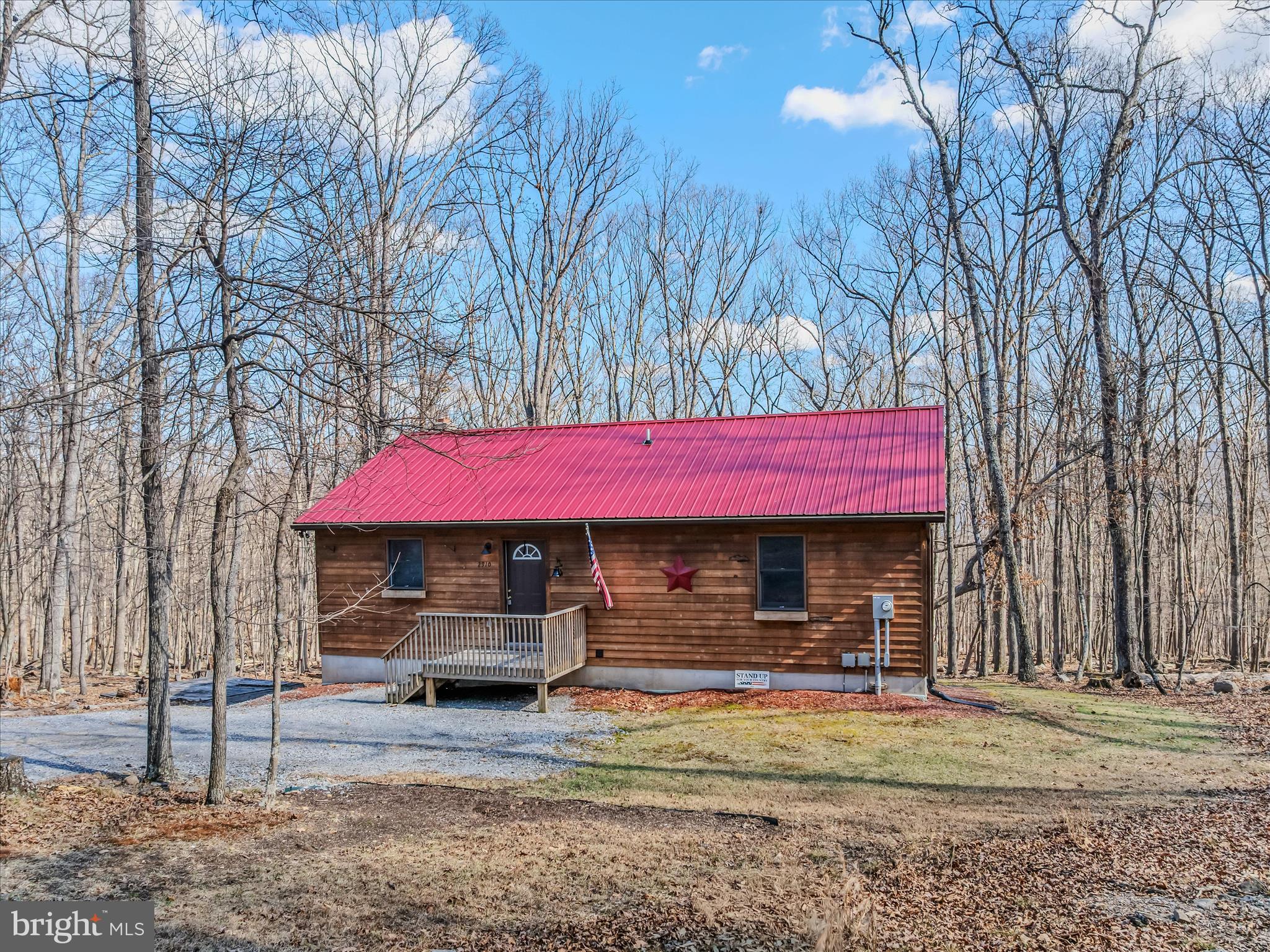 2910 Milo School Road Great Cacapon, WV 25422 - Photo 2 of 55 a front view of a house with garden
