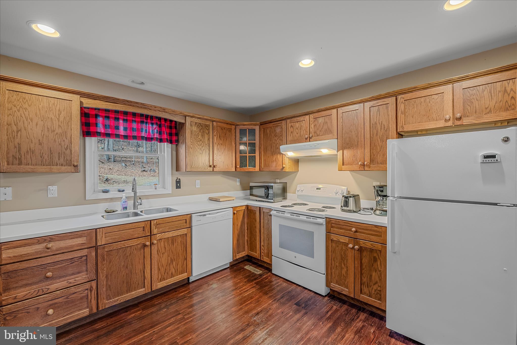 2910 Milo School Road Great Cacapon, WV 25422 - Photo 8 of 55 a kitchen with a sink a stove a refrigerator and cabinets