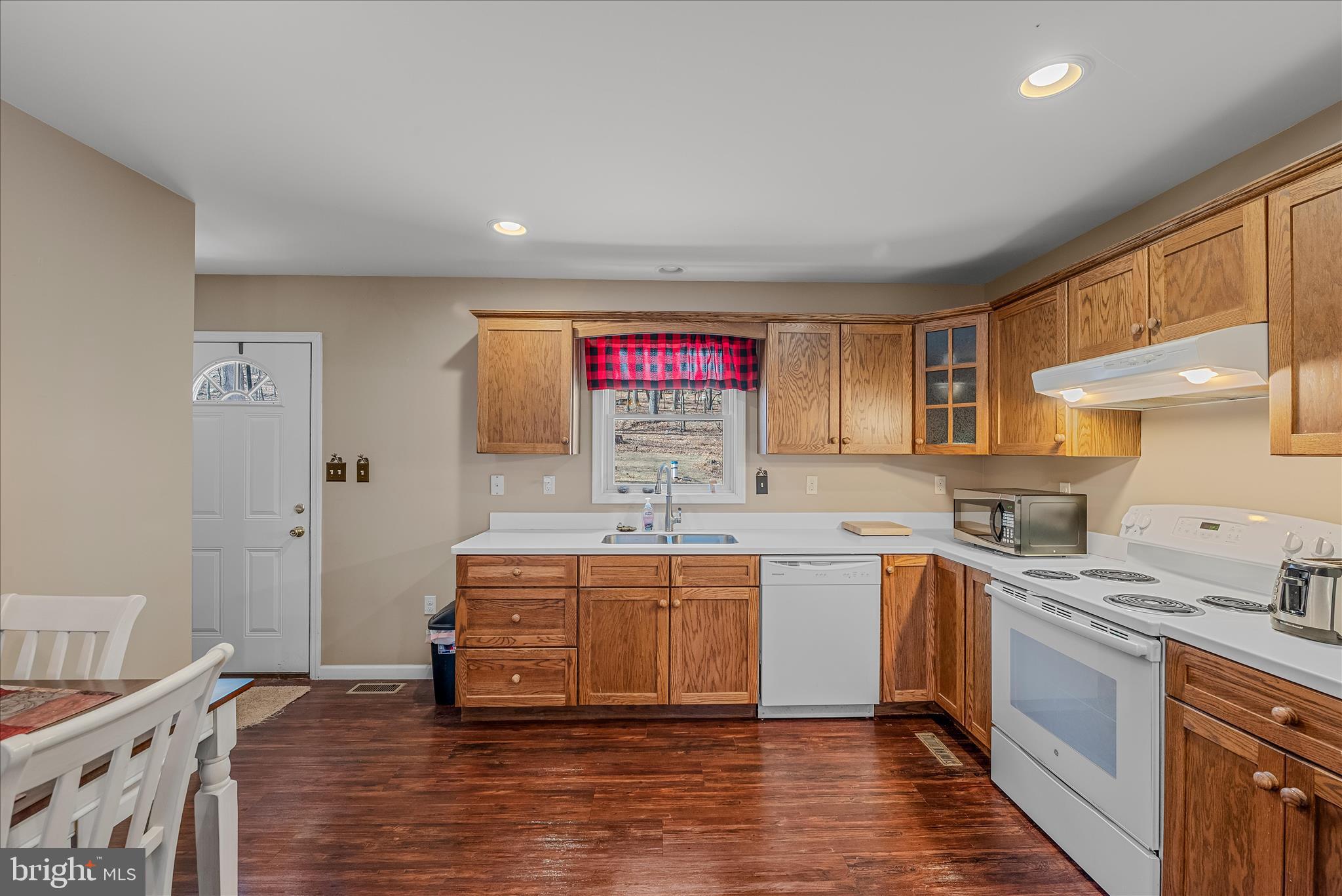 2910 Milo School Road Great Cacapon, WV 25422 - Photo 9 of 55 a kitchen with stainless steel appliances granite countertop a sink and cabinets