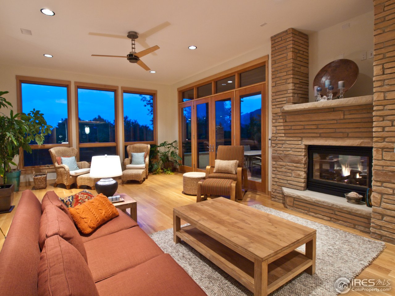 3718 Spring Valley Road Boulder, CO 80304 - Photo 13 of 25 a living room with furniture a fireplace and a floor to ceiling window