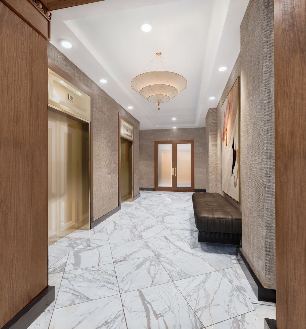 850 North Lake Shore Drive, Unit 709 Chicago, IL 60611 - Photo 5 of 18 a spacious bathroom with a granite countertop sink a mirror and vanity