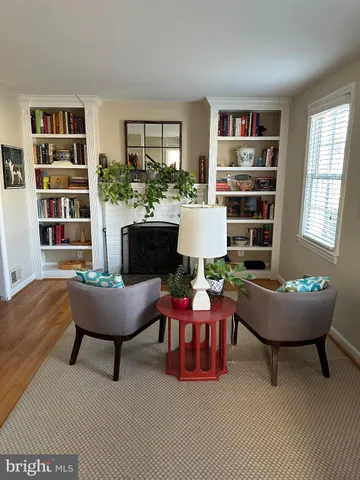 a living room with furniture and a book shelf