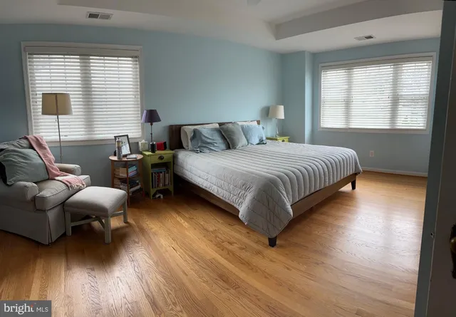 a spacious bedroom with a bed and a couch