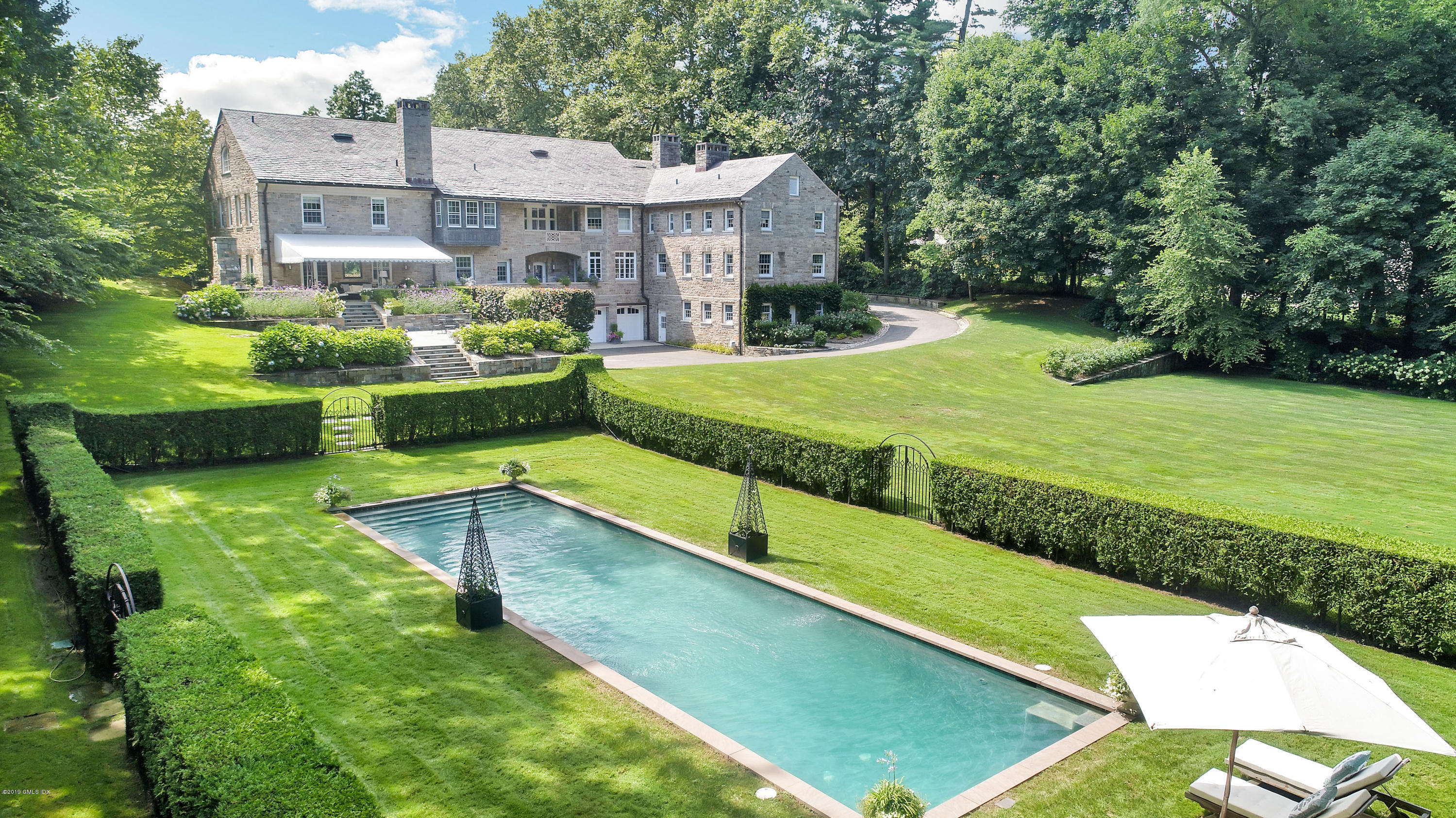 29 Hillside Road Greenwich, CT 06830 - Photo 1 of 1 a view of an house with swimming pool garden and outdoor seating