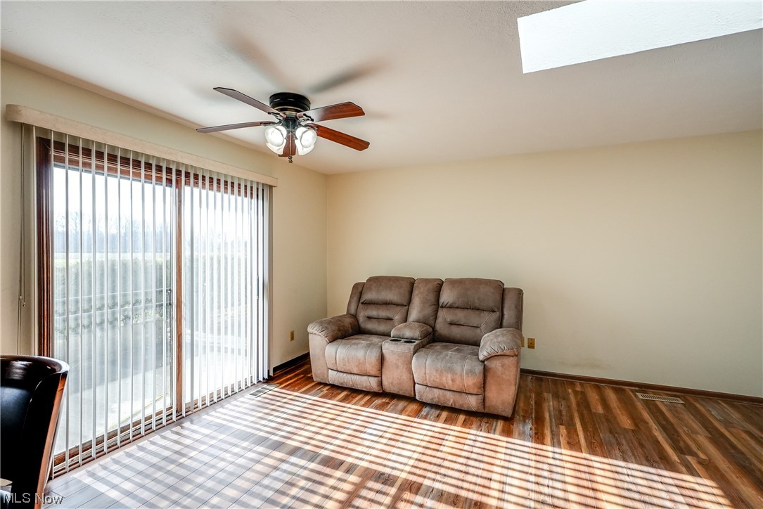 13920 Kneisel Road Vermilion, OH 44089 - Photo 11 of 35 Living room with dark hardwood / wood-style floors, a skylight, and ceiling fan